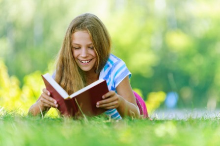 a little girl reading a book
