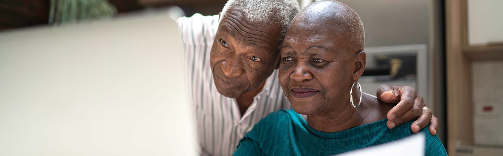 a mature couple looking at a screen