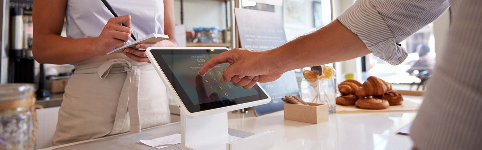 a person paying for a purchase at a coffee shop.