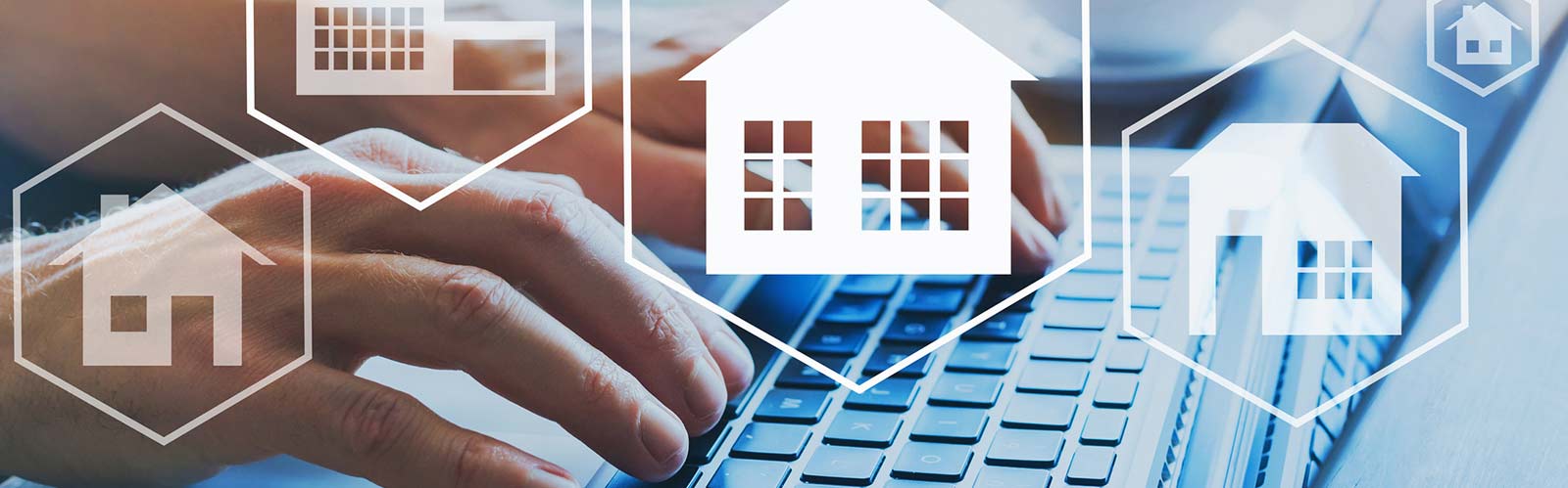transparent house images in front of a laptop keyboard