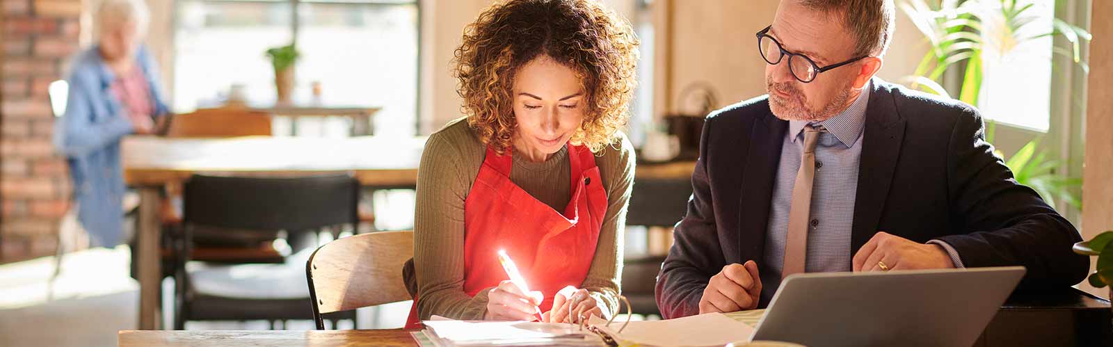 Two people working on business documents header image