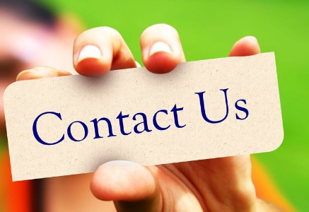 a hand holding a contact us card