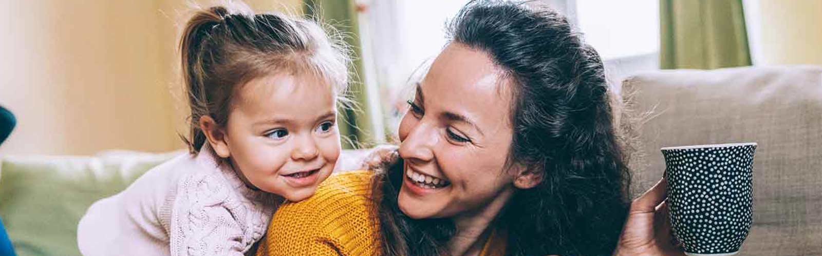 a mother and daughter smiling