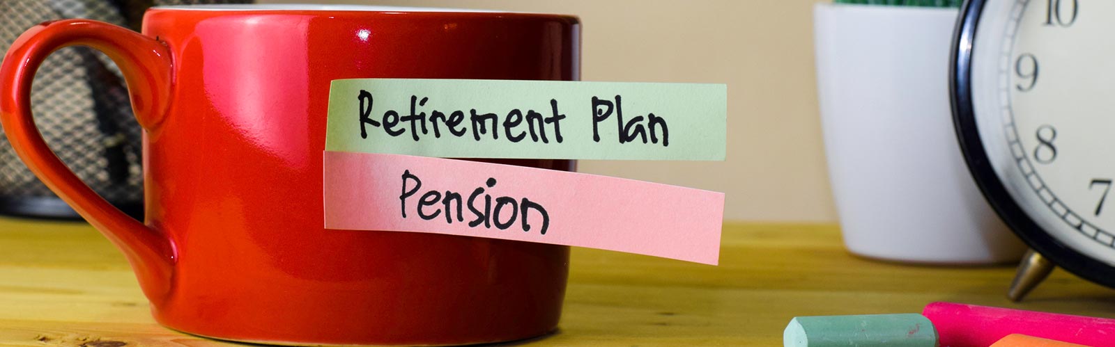 a red mug with retirement plan and pension tabs