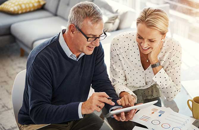 Couple doing finances on their tablet.