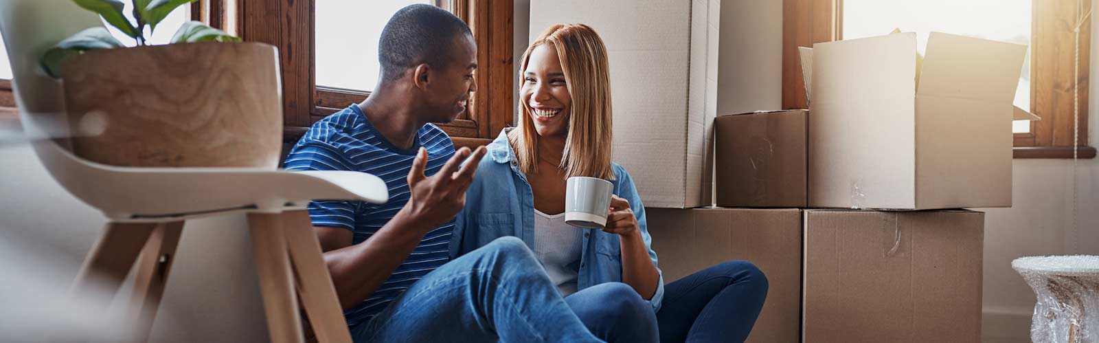 a couple sitting in their new house