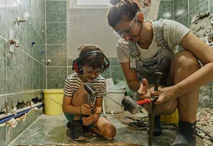 Mother and son remodelling the bathroom.