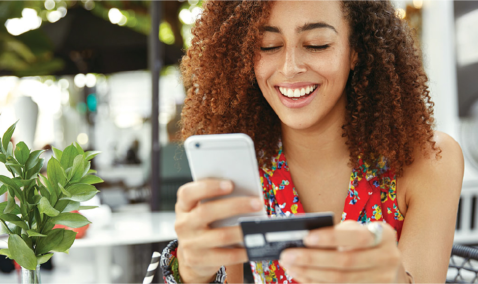 a woman holding her mobile device making an online purchase