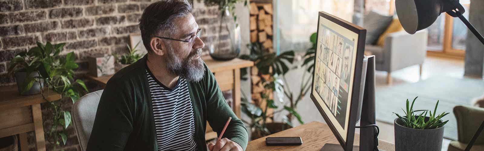 a man viewing a desktop computer monitor header image